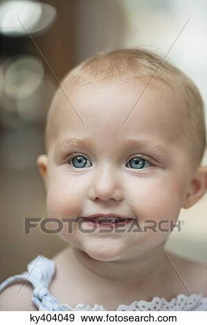 Stock Photo - Close-up of a baby girl smiling. Fotosearch