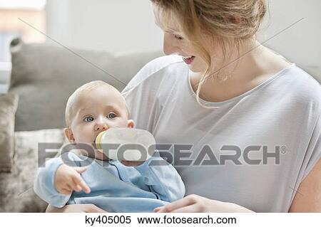 Baby girl feeding on milk with a milk bottle View Large Photo Image Stock Photography - Baby girl feeding on milk with a milk bottle. Fotosearch