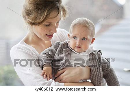 Close-up of a woman playing with her daughter View Large Photo Image Stock Image - Close-up of a woman playing with her daughter. Fotosearch