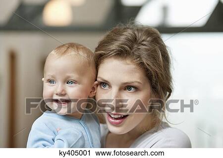Stock Image - Close-up of a woman with her baby girl. Fotosearch