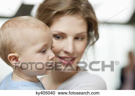 Stock Image - Close-up of a woman with her baby girl. Fotosearch