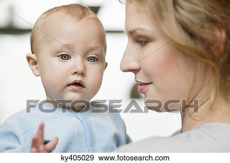 Stock Photo - Close-up of a woman with her baby girl. Fotosearch