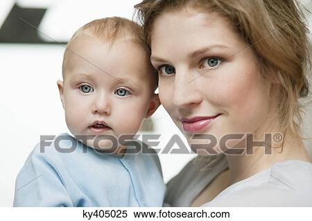 Close-up of a woman with her baby girl View Large Photo Image Stock Photography - Close-up of a woman with her baby girl. Fotosearch