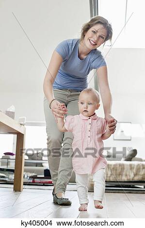 Mother helping baby to walk View Large Photo Image Picture - Mother helping baby to walk. Fotosearch