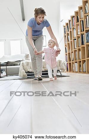 Mother helping baby to walk View Large Photo Image Picture - Mother helping baby to walk. Fotosearch