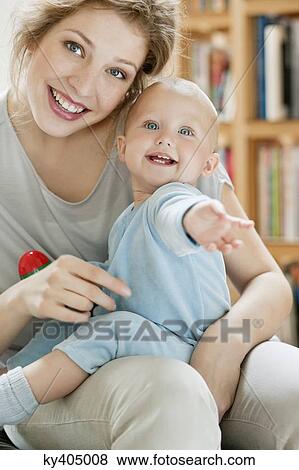 Stock Photo - Portrait of a woman playing with her daughter. Fotosearch