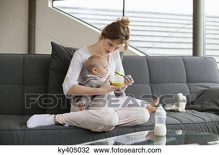 Woman feeding her daughter View Large Photo Image Stock Image - Woman feeding her daughter. Fotosearch