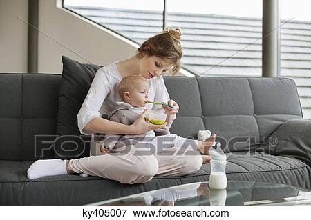 Woman feeding her daughter View Large Photo Image Stock Photo - Woman feeding her daughter. Fotosearch