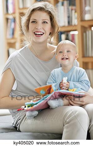 Stock Image - Woman laughing with her baby girl. Fotosearch