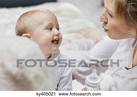 Woman playing with her daughter and smiling View Large Photo Image Stock Image - Woman playing with her daughter and smiling. Fotosearch