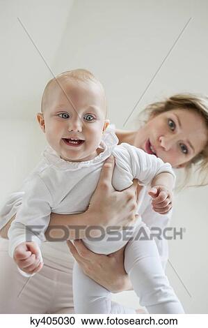 Woman playing with her daughter and smiling View Large Photo Image Stock Image - Woman playing with her daughter and smiling. Fotosearch