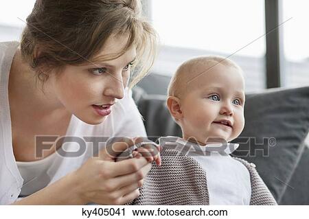 Stock Image - Woman playing with her daughter. Fotosearch