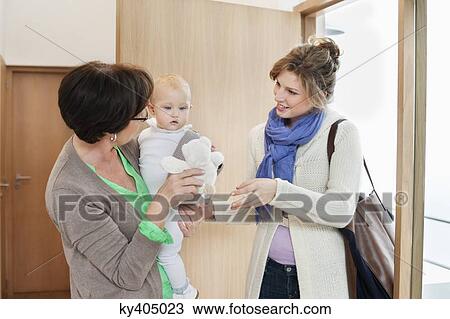 Woman showing a teddy bear to a baby girl View Large Photo Image Stock Image - Woman showing a teddy bear to a baby girl. Fotosearch