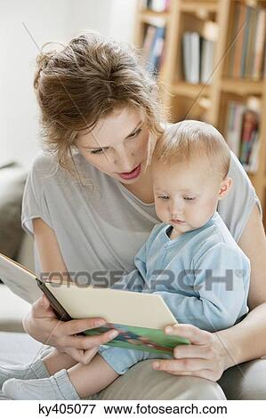 Woman teaching her daughter from a picture book View Large Photo Image Stock Photo - Woman teaching her daughter from a picture book. Fotosearch