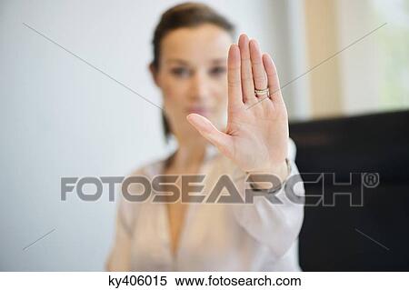 Businesswoman showing her wedding ring with stop gesture View Large Photo Image Stock Photography - Businesswoman showing her wedding ring with stop gesture. Fotosearch