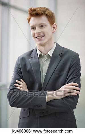 Close-up of a businessman smiling with his arms crossed in an office View Large Photo Image Stock Photograph - Close-up of a businessman smiling with his arms crossed in an office. Fotosearch