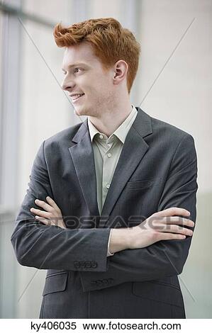 Close-up of a businessman smiling with his arms crossed in an office View Large Photo Image Stock Photography - Close-up of a businessman smiling with his arms crossed in an office. Fotosearch