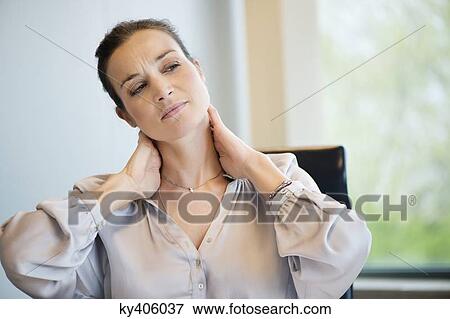 Close-up of a businesswoman suffering from neckache View Large Photo Image Stock Photo - Close-up of a businesswoman suffering from neckache. Fotosearch
