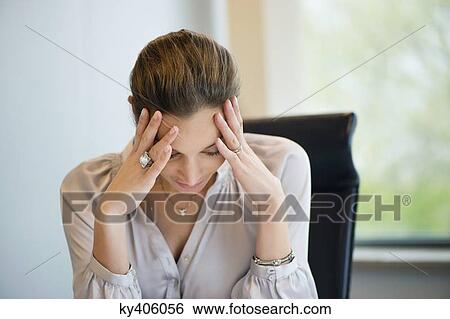 Close-up of a businesswoman suffering from a headache in an office View Large Photo Image Stock Photograph - Close-up of a businesswoman suffering from a headache in an office. Fotosearch