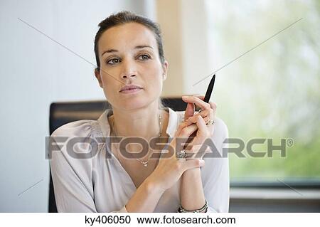 Close-up of a businesswoman thinking in an office View Large Photo Image Stock Image - Close-up of a businesswoman thinking in an office. Fotosearch