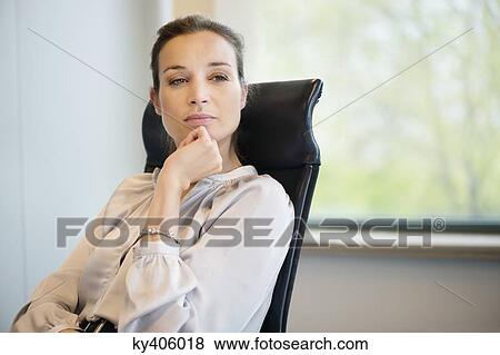 Close-up of a businesswoman thinking in an office View Large Photo Image Stock Photo - Close-up of a businesswoman thinking in an office. Fotosearch