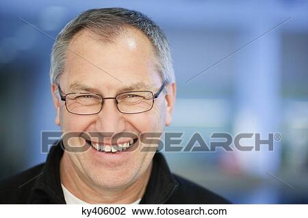 Portrait of a businessman smiling View Large Photo Image Stock Image - Portrait of a businessman smiling. Fotosearch