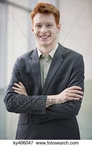 Portrait of a businessman smiling with arms crossed View Large Photo Image Stock Photo - Portrait of a businessman smiling with arms crossed. Fotosearch