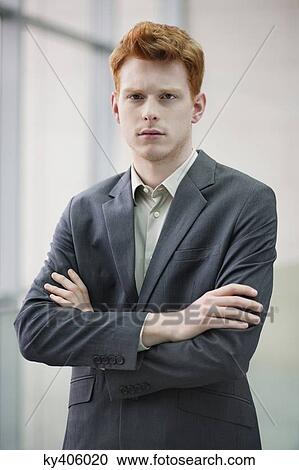 Portrait of a businessman with arms crossed in an office View Large Photo Image Stock Image - Portrait of a businessman with arms crossed in an office. Fotosearch
