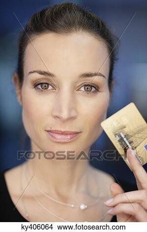 Portrait of a businesswoman holding a credit card View Large Photo Image Picture - Portrait of a businesswoman holding a credit card. Fotosearch