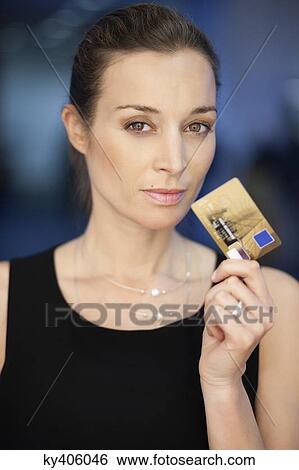 Portrait of a businesswoman holding a credit card View Large Photo Image Stock Photograph - Portrait of a businesswoman holding a credit card. Fotosearch