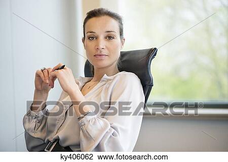 Portrait of a businesswoman in an office View Large Photo Image Stock Image - Portrait of a businesswoman in an office. Fotosearch