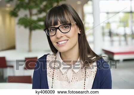 Stock Photo - Portrait of a businesswoman smiling in an office. Fotosearch