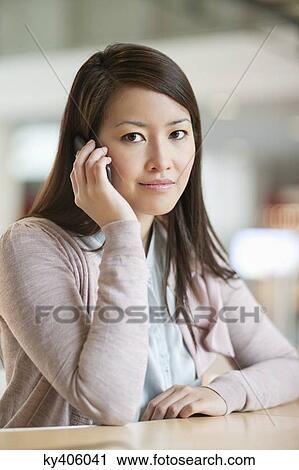 Portrait of a businesswoman talking on a mobile phone in an office View Large Photo Image Stock Image - Portrait of a businesswoman talking on a mobile phone in an office. Fotosearch