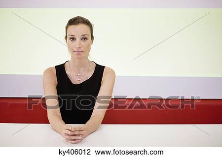 Portrait of a businesswoman with her hands clasped in an office View Large Photo Image Stock Image - Portrait of a businesswoman with her hands clasped in an office. Fotosearch
