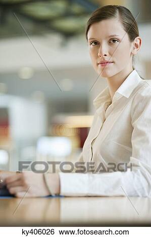Stock Photograph - Portrait of a businesswoman working in an office. Fotosearch