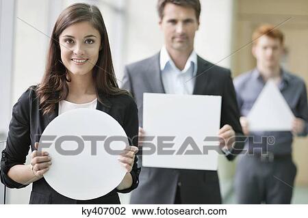 Business executives holding geometrical shaped placards in an office View Large Photo Image Stock Image - Business executives holding geometrical shaped placards in an office. Fotosearch