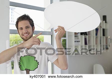 Stock Image - Man holding a speech bubble. Fotosearch