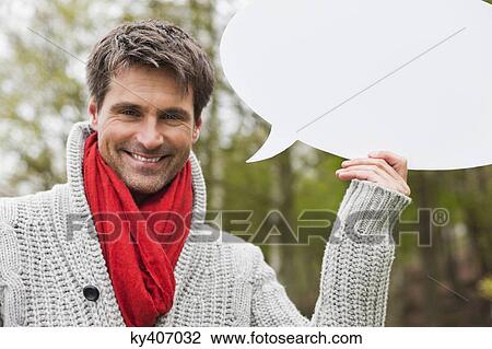 Man holding a speech bubble View Large Photo Image Stock Image - Man holding a speech bubble. Fotosearch