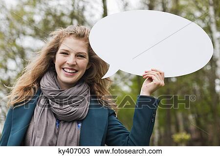 Stock Image - Woman holding a speech bubble. Fotosearch