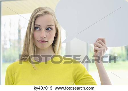 Woman holding a speech bubble View Large Photo Image Stock Image - Woman holding a speech bubble. Fotosearch