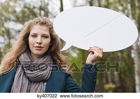 Stock Image - Woman holding a speech bubble. Fotosearch