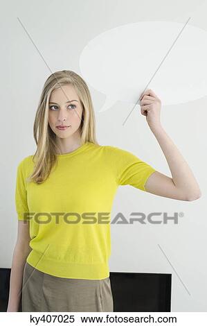 Woman holding a speech bubble View Large Photo Image Stock Photography - Woman holding a speech bubble. Fotosearch