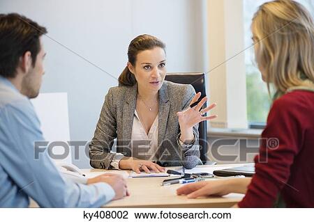 Business executive discussing with her clients View Large Photo Image Stock Image - Business executive discussing with her clients. Fotosearch