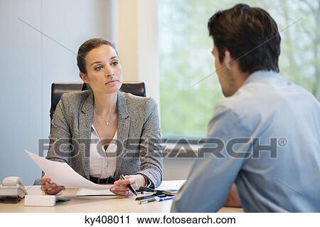 Stock Image - Business executive discussing with her client. Fotosearch
