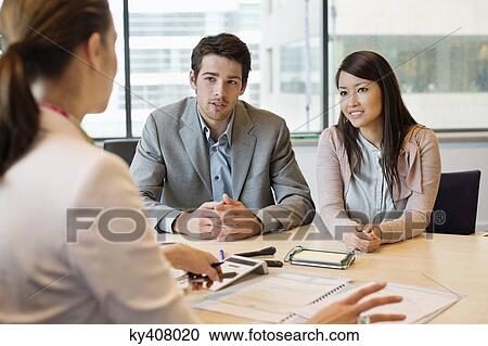 Stock Image - Business executive discussing with her clients. Fotosearch