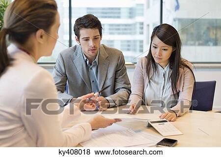 Business executive discussing with her clients View Large Photo Image Stock Photo - Business executive discussing with her clients. Fotosearch