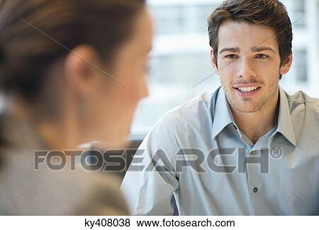 Business executive discussing with her client View Large Photo Image Stock Photo - Business executive discussing with her client. Fotosearch