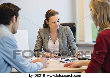 Stock Photograph - Business executive discussing with her clients. Fotosearch