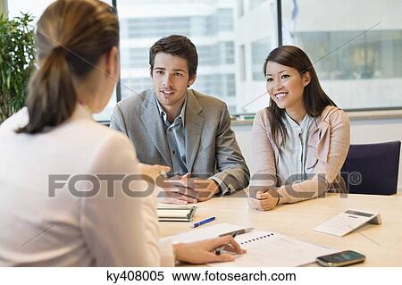 Business executive discussing with her clients View Large Photo Image Stock Photography - Business executive discussing with her clients. Fotosearch