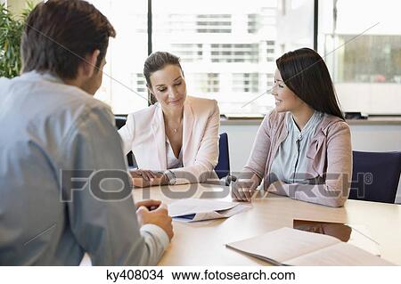 Picture - Business executive discussing with his clients. Fotosearch